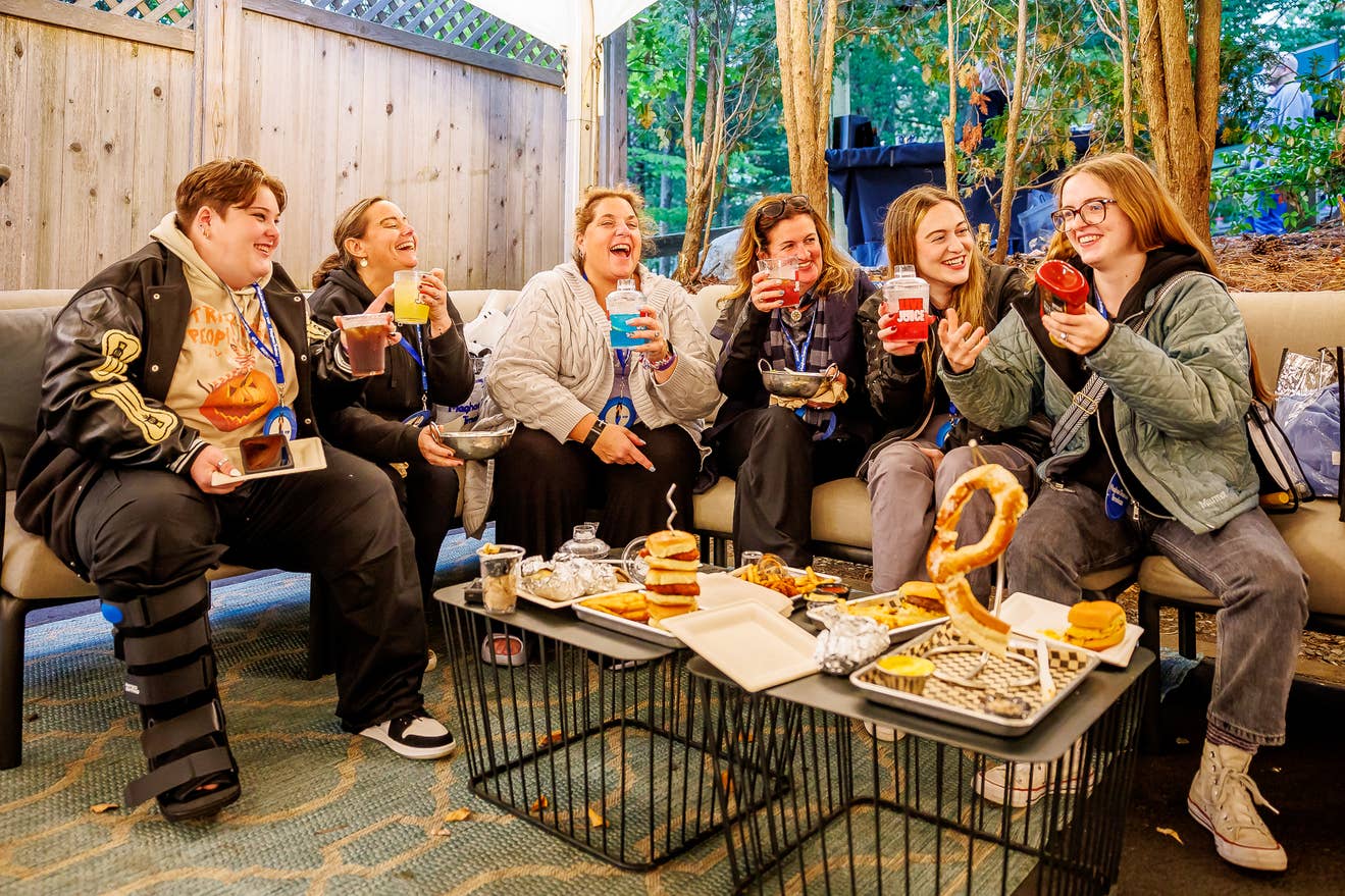 photo of 6 fans in the VIP club enjoying food and drinks