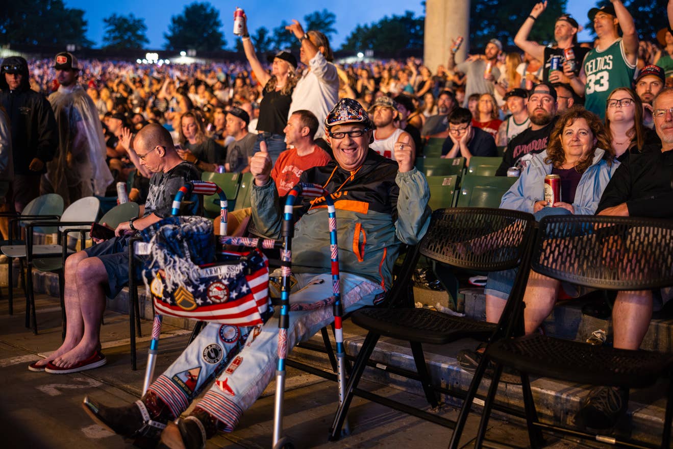 a fan in accessible seating giving a thumbs up