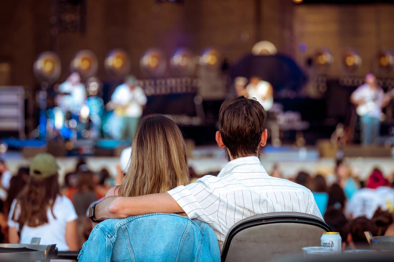 a couple sitting together at a show
