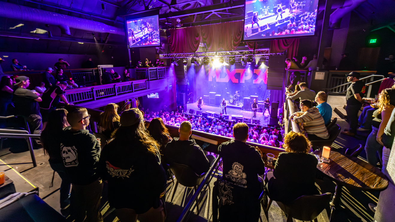 People watch a show at The Depot from the balcony