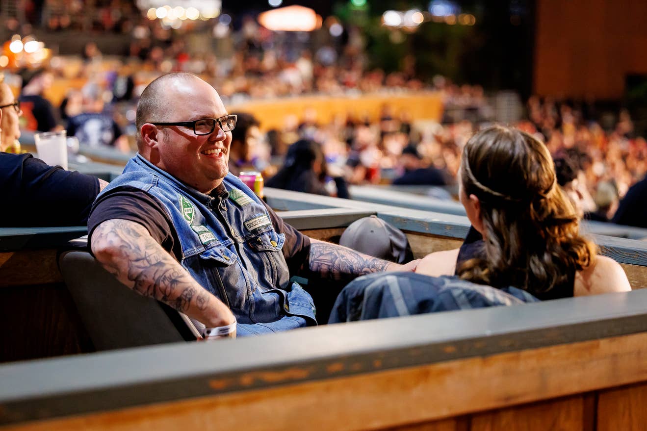 photo of a fan in a box suite smiling.