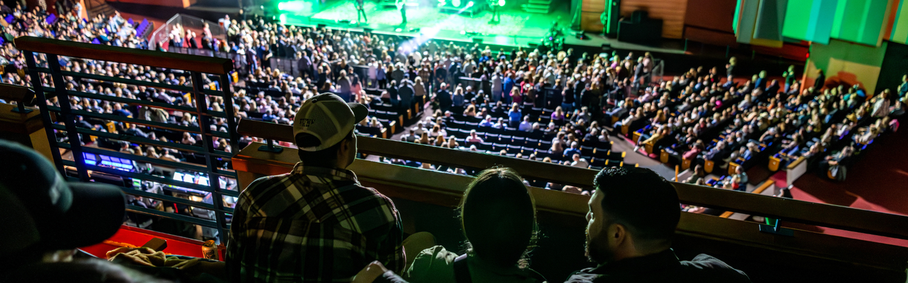 Fans are front row in a suite box watching the show